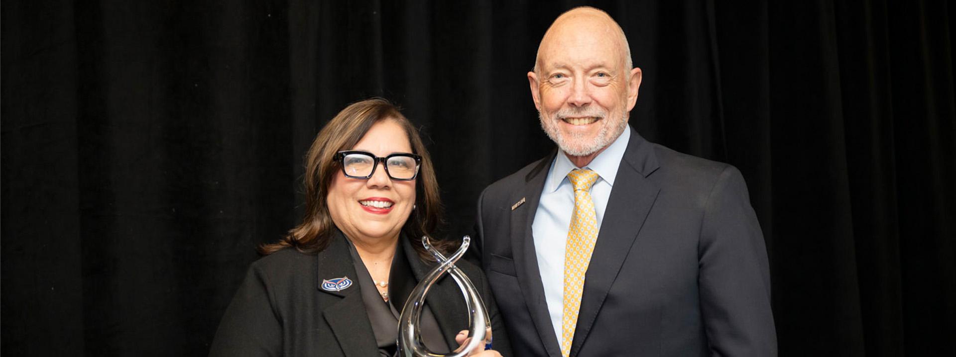 Ted Mitchell, president of ACE, presents FAU President Stacy Volnick with the 2024 American Council on Education