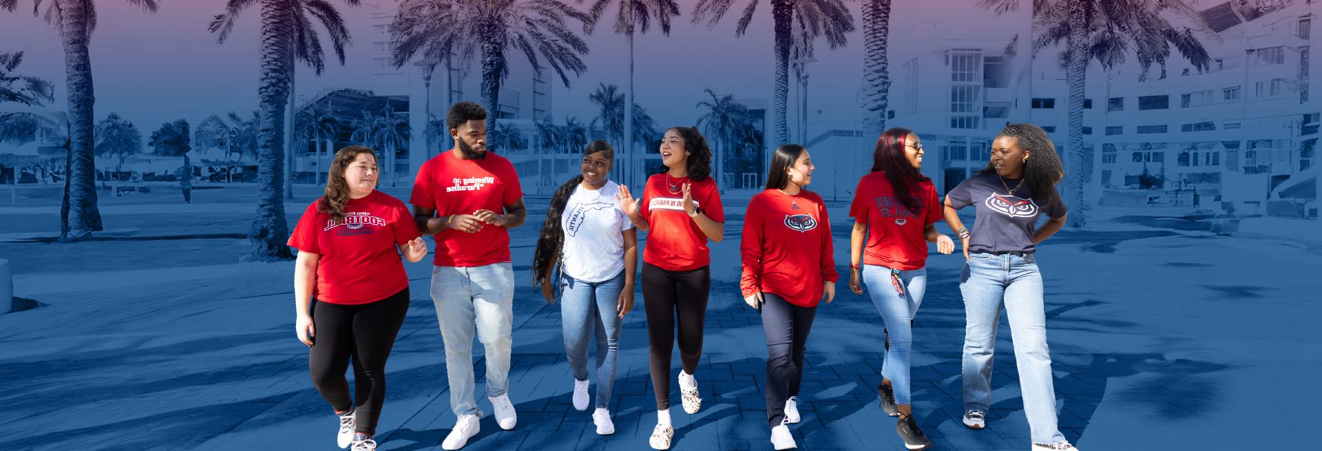 Red and Blue Weeks - A group of students wearing red Florida Atlantic t-shirts while strolling on campus